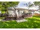 Green backyard with a spacious deck, accessed by steps and leading to the home's exterior doors and windows at 11419 Niagara Dr, Fishers, IN 46037