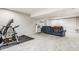 Finished basement features a recreational area with exercise equipment, a couch, and a projector screen at 11419 Niagara Dr, Fishers, IN 46037