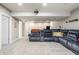 Fully finished basement with neutral carpeting, built-in projector, and comfortable seating at 11419 Niagara Dr, Fishers, IN 46037