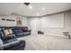 The basement has a projector screen, a gray carpet, and a comfy blue couch at 11419 Niagara Dr, Fishers, IN 46037