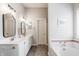 Bright bathroom with dual sinks, white cabinets and a large mirror at 11419 Niagara Dr, Fishers, IN 46037