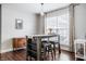 Bright dining area with natural light, modern pendant light fixture, and cozy seating adjacent to the kitchen at 11419 Niagara Dr, Fishers, IN 46037