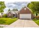 Inviting brick home with well-maintained lawn and spacious driveway leading to a two-car garage at 11419 Niagara Dr, Fishers, IN 46037