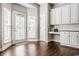 Kitchen area with white cabinetry and subway tile detail, convenient built-in desk space, and adjacent dining nook at 11419 Niagara Dr, Fishers, IN 46037