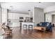 Open-concept living space with white cabinets, stainless appliances, hardwood floors, and comfortable seating at 11419 Niagara Dr, Fishers, IN 46037