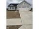 Charming single-story home with a large garage, gray siding, and a neatly paved driveway at 1193 Brightwood Cir, Greenfield, IN 46140