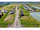 Expansive aerial view of new neighborhood with lush green spaces and scenic pond at 1204 Mcbride St, Greenfield, IN 46140