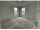 Bedroom featuring two windows and unfinished flooring at 1204 Mcbride St, Greenfield, IN 46140