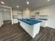 Spacious kitchen featuring white cabinets, an island, and modern fixtures at 1204 Mcbride St, Greenfield, IN 46140