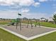 Community playground featuring swings, slides, and seating with several homes in the background at 1204 Mcbride St, Greenfield, IN 46140