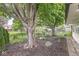 Landscaped backyard with lush greenery, mulch beds, and mature trees creating a serene outdoor space at 12388 Camberley Ln, Carmel, IN 46033