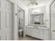 Well-lit bathroom with a vanity, mirror, and a view into the bedroom, offering a clean and functional space at 12388 Camberley Ln, Carmel, IN 46033