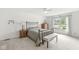 Light and airy bedroom featuring a large window, carpet flooring, and neutral decor at 12388 Camberley Ln, Carmel, IN 46033