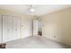 Spacious bedroom featuring a ceiling fan, double closets, and neutral wall color at 12388 Camberley Ln, Carmel, IN 46033