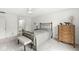 Bright bedroom with neutral decor, a glimpse into the ensuite bathroom, and ample storage at 12388 Camberley Ln, Carmel, IN 46033