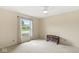 Bright bedroom with a ceiling fan, large window, and a glimpse of the neighborhood at 12388 Camberley Ln, Carmel, IN 46033