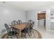 Comfortable dining area includes a wooden table, chairs, light flooring, and a view to the laundry room at 12388 Camberley Ln, Carmel, IN 46033