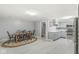 Dining area features a wooden table with chairs, light flooring, and access to the modern kitchen at 12388 Camberley Ln, Carmel, IN 46033