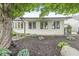 Exterior view highlighting well-maintained mulch beds, symmetrical window design, and mature shade trees at 12388 Camberley Ln, Carmel, IN 46033