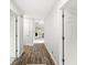 Inviting hallway with wood floors that leads to a bright living area with neutral colors at 12388 Camberley Ln, Carmel, IN 46033
