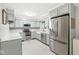 Modern kitchen boasts stainless steel appliances, light blue cabinetry, and bright countertops at 12388 Camberley Ln, Carmel, IN 46033