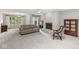 Bright living room features fireplace, neutral colors, large windows and a chandelier at 12388 Camberley Ln, Carmel, IN 46033
