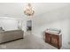 Spacious living room, chandelier, natural light, flows to dining room with view of front yard at 12388 Camberley Ln, Carmel, IN 46033