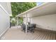 Covered patio with wood decking and outdoor dining set, perfect for enjoying outdoor meals at 12388 Camberley Ln, Carmel, IN 46033