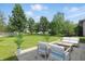 Relax on the patio with outdoor seating and a large grassy backyard surrounded by mature trees at 12409 Dellfield W Blvd, Carmel, IN 46033