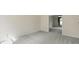 Neutral bedroom features plush carpet, light walls, and open doorway to adjacent living area at 12409 Dellfield W Blvd, Carmel, IN 46033