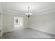 Formal dining room featuring carpet, a chandelier, and ample natural light at 12409 Dellfield W Blvd, Carmel, IN 46033