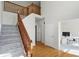 View of the foyer with hardwood floors, wooden banister, and stairway with carpet runner at 12409 Dellfield W Blvd, Carmel, IN 46033