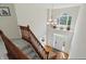 Bright foyer features staircase, hardwood entryway, and large window illuminating the space at 12409 Dellfield W Blvd, Carmel, IN 46033