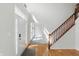 Bright foyer featuring hardwood floors, staircase with wood railing, and a front door with sidelight windows at 12409 Dellfield W Blvd, Carmel, IN 46033