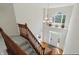 View from second floor of foyer with hardwood floors and stairway with carpet runner at 12409 Dellfield W Blvd, Carmel, IN 46033