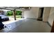 Spacious two-car garage featuring epoxy flooring and open door at 12409 Dellfield W Blvd, Carmel, IN 46033