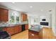 Inviting kitchen features granite countertops, wood cabinets, wood floors, and stainless appliances at 12409 Dellfield W Blvd, Carmel, IN 46033