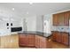 Gourmet kitchen features granite countertops, wood cabinets, and open floorplan at 12409 Dellfield W Blvd, Carmel, IN 46033