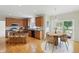 Eat-in kitchen with wooden cabinets, granite counters, stainless appliances, and wood floors at 12409 Dellfield W Blvd, Carmel, IN 46033