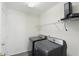 Functional laundry area features modern washer, dryer, shelving, and ample space at 12409 Dellfield W Blvd, Carmel, IN 46033