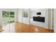 Open-concept living area with hardwood floors, sliding glass doors, and a view to an adjacent Gathering room at 12409 Dellfield W Blvd, Carmel, IN 46033