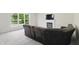 Bright living room with fireplace and large windows providing backyard views at 12409 Dellfield W Blvd, Carmel, IN 46033