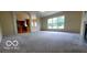 Living room featuring an open concept design with fireplace and kitchen view at 12409 Dellfield W Blvd, Carmel, IN 46033