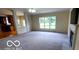 Spacious living room with fireplace and large windows offering exterior views at 12409 Dellfield W Blvd, Carmel, IN 46033