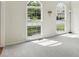 Bright living room featuring large windows offering plenty of natural light and backyard views at 12409 Dellfield W Blvd, Carmel, IN 46033