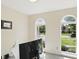 An interior view of the home office showing the arched windows and view to the outdoors at 12409 Dellfield W Blvd, Carmel, IN 46033