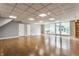 Large finished basement with hardwood floors, recessed lighting, and bright light from the outside at 12469 Springmill Rd, Carmel, IN 46032