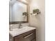 Bathroom features a modern sink, decorative mirror, and stylish fixtures, creating a cozy and functional space at 12469 Springmill Rd, Carmel, IN 46032