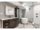 Modern bathroom with sleek vanity, soaking tub, and tiled shower at 12469 Springmill Rd, Carmel, IN 46032