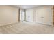 Well-lit bedroom with neutral carpet and paint, window with backyard view, and closet at 12469 Springmill Rd, Carmel, IN 46032